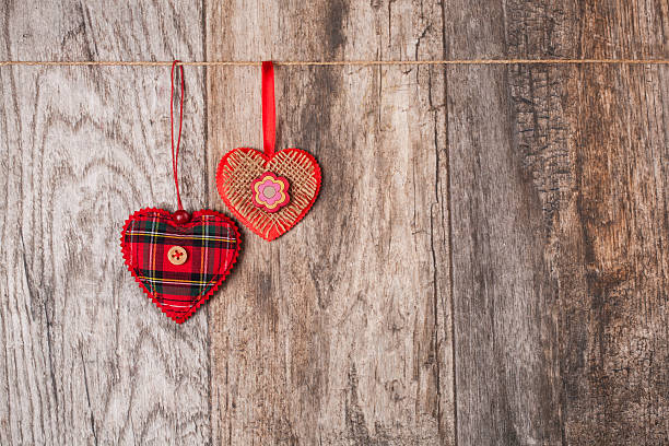 hearts - heart shape textile button hanging stock-fotos und bilder