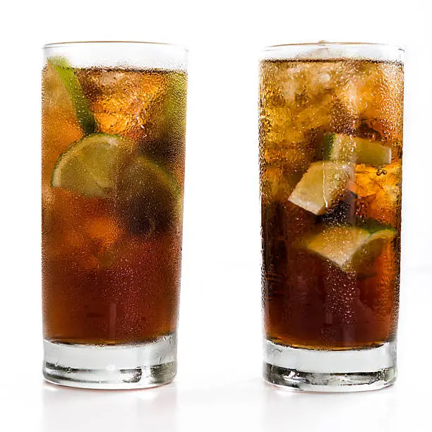 Cuba Libre Longdrink with brown rum and lime (isolated on white background)