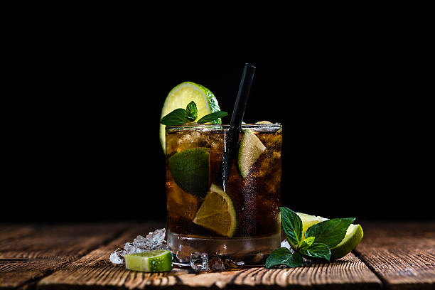 Fresh made Cuba Libre Fresh made Cuba Libre with brown rum and tasty lime cuba libre stock pictures, royalty-free photos & images