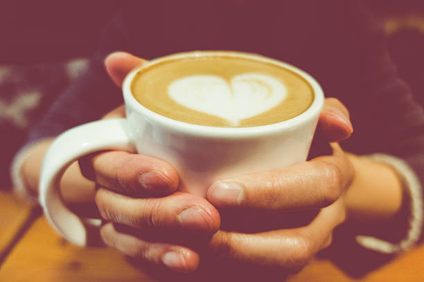 Close-up on Woman's Hands Holding a Cup of Coffee