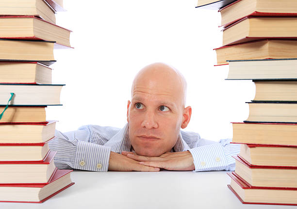 istock Man between piles of books 499753260