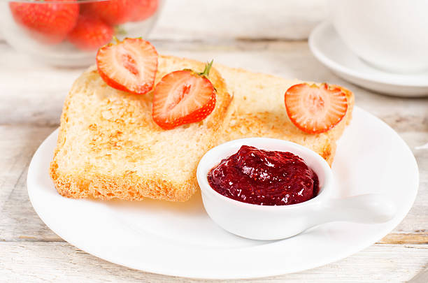 istock breakfast with fresh toasts, strawberries and strawberry jam 499753939