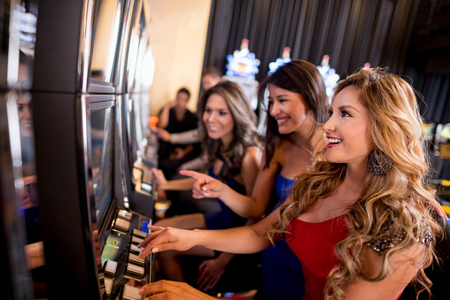 Women playing on the slot machines at the casino