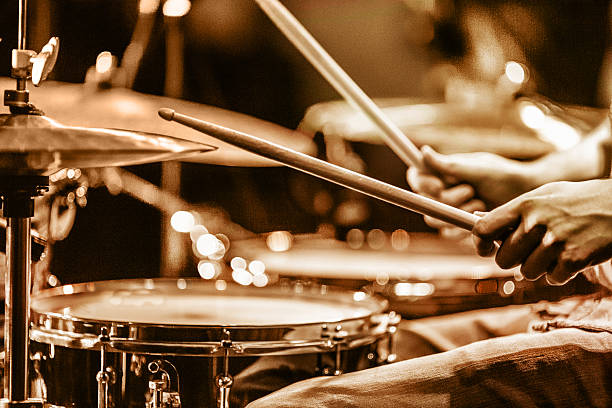 Drummer playing drums on stage view and shot from backstage: drummer playing hi hat and snare drum percussion instrument stock pictures, royalty-free photos & images
