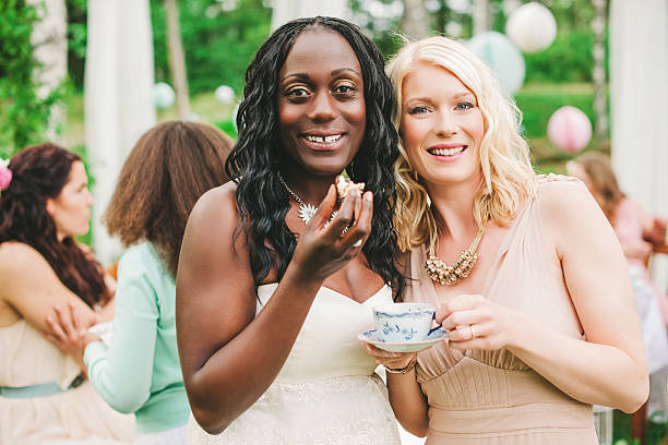 istock Women having a garden party with dessert table 499755357