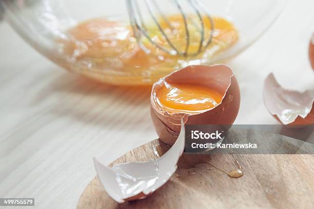 Cracked Egg Atop Wooden Kitchen Counter Stock Photo - Download Image Now - Animal Egg, Backgrounds, Baked