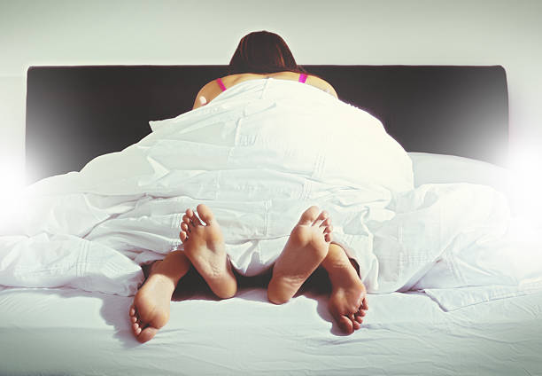 Woman on top. Anonymous couple having sex An anonymous couple make love under a duvet, the woman on top. orgasm women female sexual issues stock pictures, royalty-free photos & images
