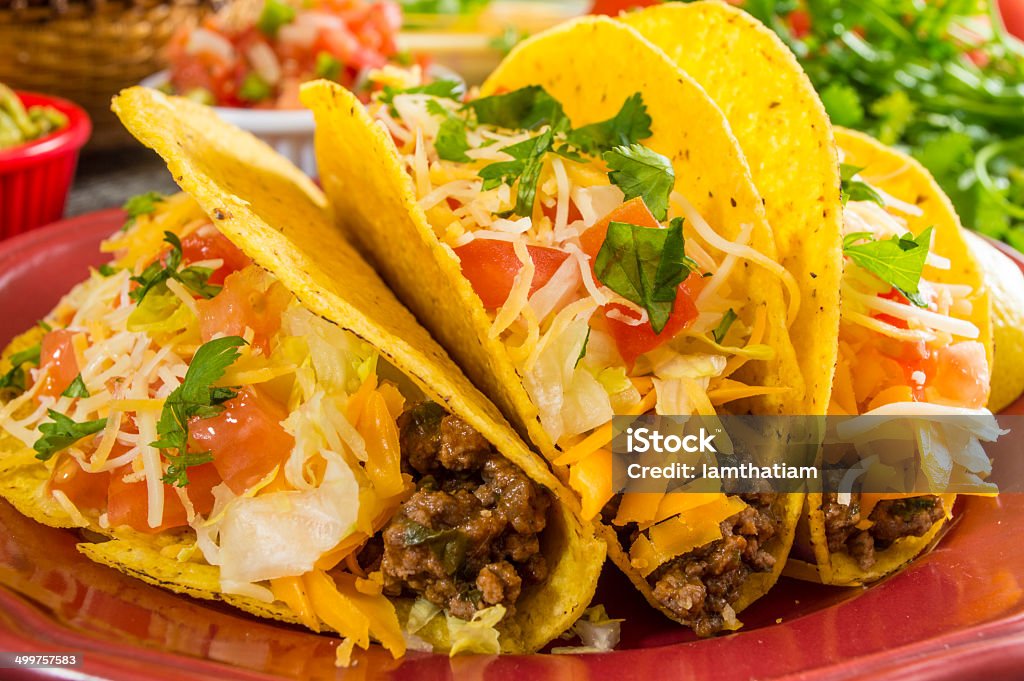 crispy beef tacos plate of crispy beef tacos with guacamole and cheese dip Beef Taco Stock Photo