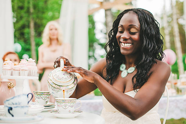 Women having a garden party with dessert table