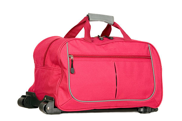 istock Pink luggage with wheels 499758233