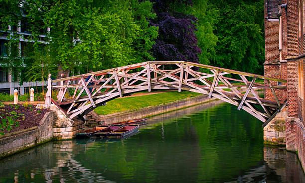Mathematical bridge Mathematical bridge in spring over Cam river next to Presidents Lodge, Cambridge, England. queens college stock pictures, royalty-free photos & images