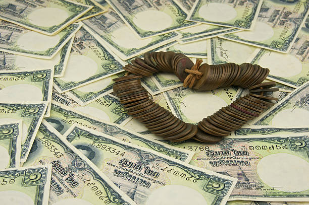 istock Close up old ancient coins Thailand as heart on bill 499760863