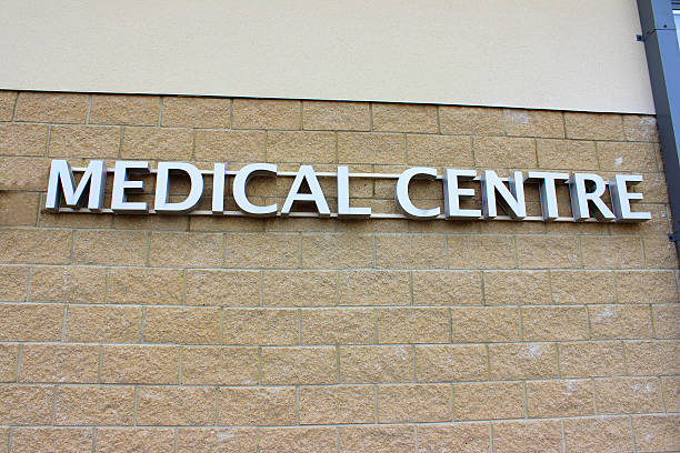 istock Image of modern silver Medical Centre sign, pale brick wall 499761147
