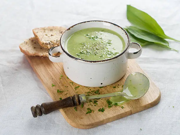 Delicious vegetable cream soup with broccoli and parsley, selective focus