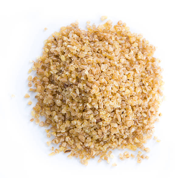 Raw Bulgur (isolated on white) Raw Bulgur (close-up shot) isolated on white background bulgur wheat stock pictures, royalty-free photos & images