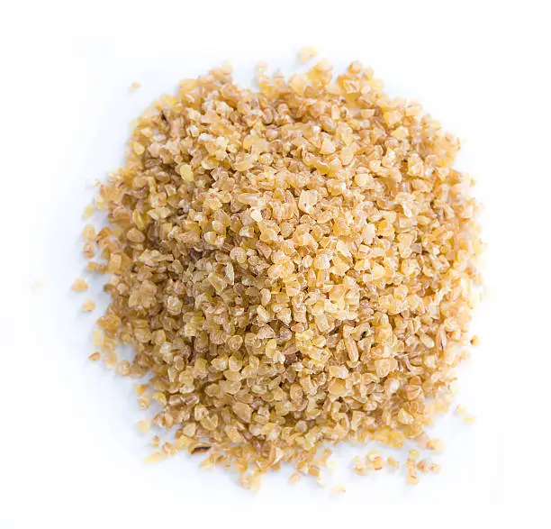 Raw Bulgur (close-up shot) isolated on white background