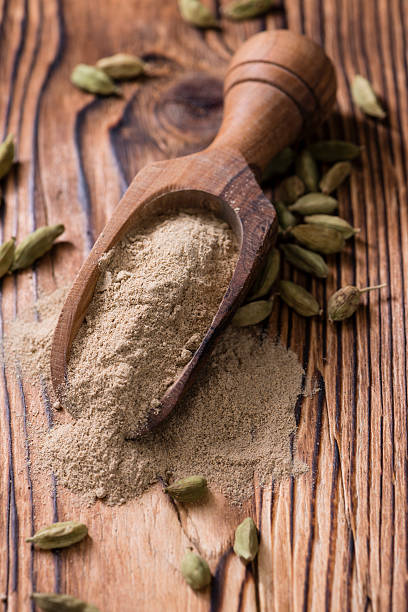 Heap of Cardamon Powder Heap of Cardamon Powder (close-up shot) on rustic wooden background cardamom stock pictures, royalty-free photos & images