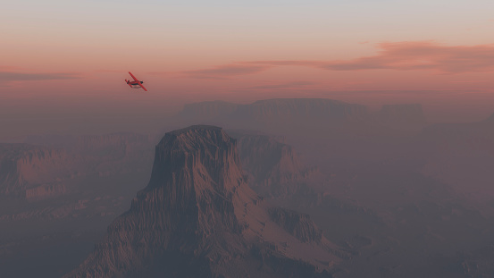 Single engine airplane flying over desert landscape at sunrise.