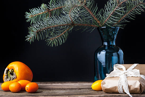 istock Fir tree branch in the vase with present and fruit 499771472