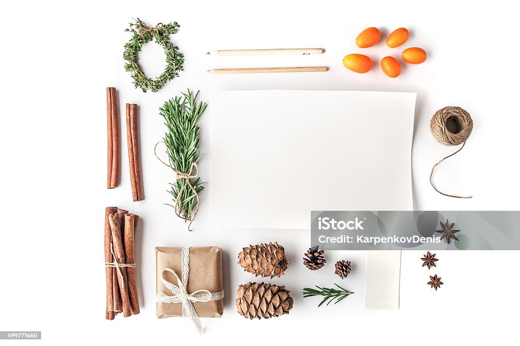 Set to create  Christmas card on the white background horizontal Rosemary , cinnamon , cones , paper , pencil , rope , kumquat , star anise and present on the white background horizontal Christmas Stock Photo