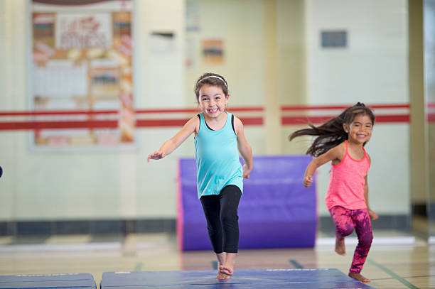 istock Little Girls Running on Gymnastics Mats 499773100
