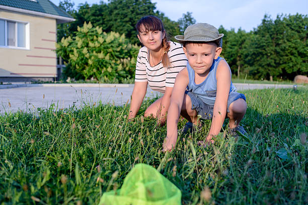 istock Little boy catching insects with his mother 499774336