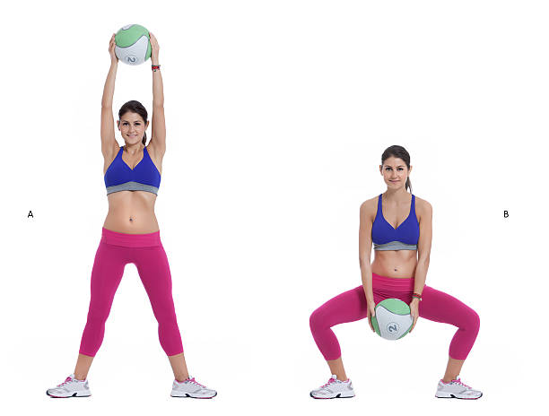 Medicine Ball Squat with Overhead Lift Step by step instructions: Stand with your feet wide, holding a light medicine ball in front of you in both hands. (A) Squat down, moving your rear back and keeping your knees over your ankles, and lower the medicine ball to the floor, keeping your head up and back straight. (B) burpee stock pictures, royalty-free photos & images