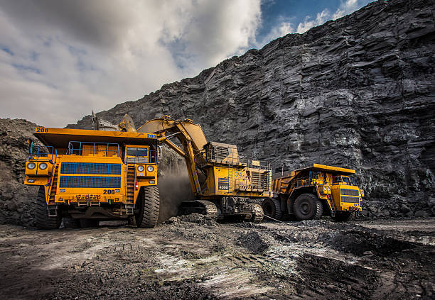 Coal production at one of the open fields Coal production at one of the open fields in the south of Siberia. Dumpers "BelAZ". September 2015.  mining natural resources photos stock pictures, royalty-free photos & images