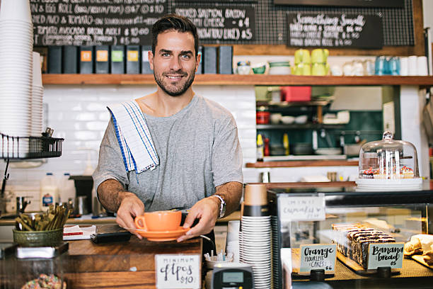 Proud Coffee Shop Owner Portrait of coffee shop owner serving a coffee. australian culture photos stock pictures, royalty-free photos & images