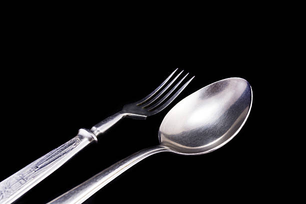 istock Spoon and fork on a black velvet 499776672