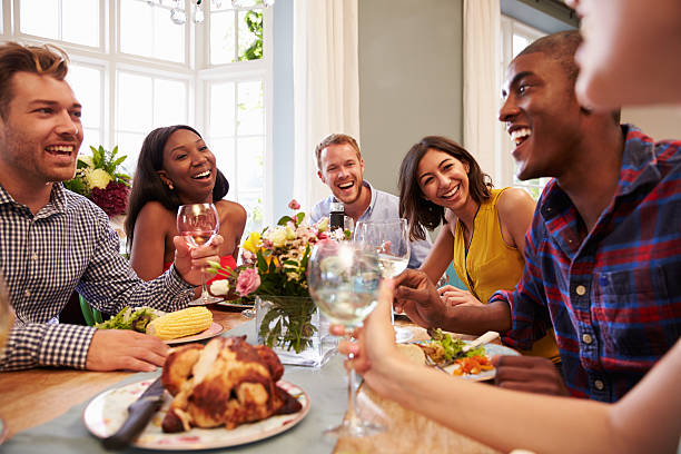 istock Friends At Home Sitting Around Table For Dinner Party 499777102