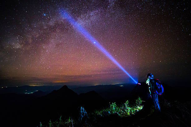 istock Young man Standing on Mountain with night sky 499779327