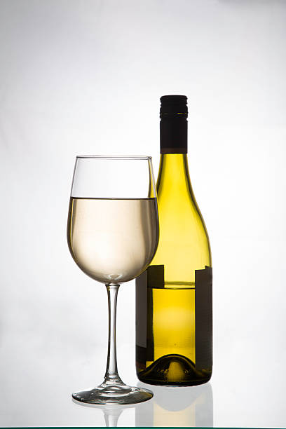istock White wine glass and bottle 499780319
