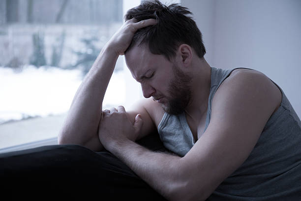 heartbroken 若い男性 - hangover men crying bed ストックフォトと画像