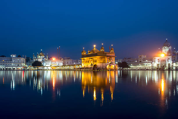 Wide angle in sunshine, Golden Temple, Amritsar, Punjab, India. The Punjab, is the state which is the heart of India’s Sikh community, bordering Pakistan. The city of Amritsar is best known for Harmandir Sahib, the holiest gurdwara, or Sikh place of worship and a major pilgrimage site. The distinctive Golden Temple, as it is known in English, is surrounded by the Pool of Nectar.