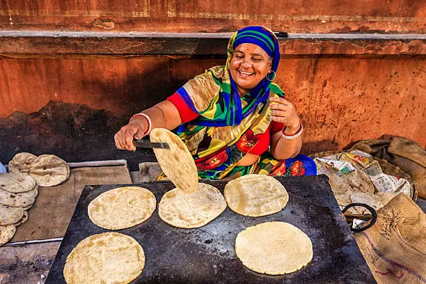 Indian street vendor preparing food - chapatti, flat bread, Jaipur - The Pink City, Rajasthan, India.  Jaipur is known as the Pink City, because of the color of the stone exclusively used for the construction of all the structures.