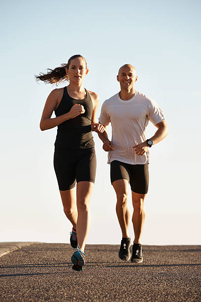 Running is it's own reward Full length shot of two young runners training outdoorshttp://195.154.178.81/DATA/i_collage/pi/shoots/783460.jpg off track running stock pictures, royalty-free photos & images