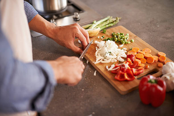 Variety is the spice of life Cropped shot of a man chopping vegetables on a countertophttp://195.154.178.81/DATA/i_collage/pi/shoots/783527.jpg chopping food stock pictures, royalty-free photos & images
