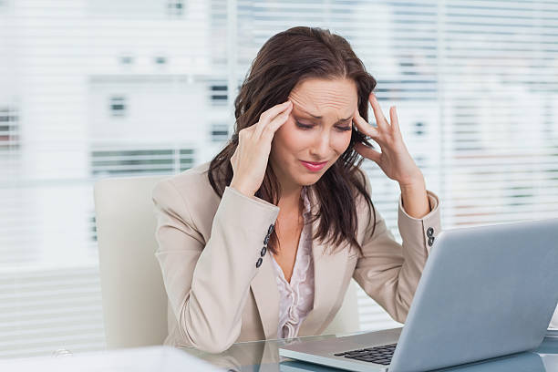 istock Tired businesswoman having a headache while working on her lapto 499782349