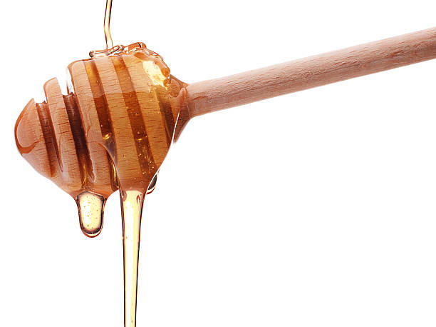 istock Honey dripping from a wooden honey dipper 499782519