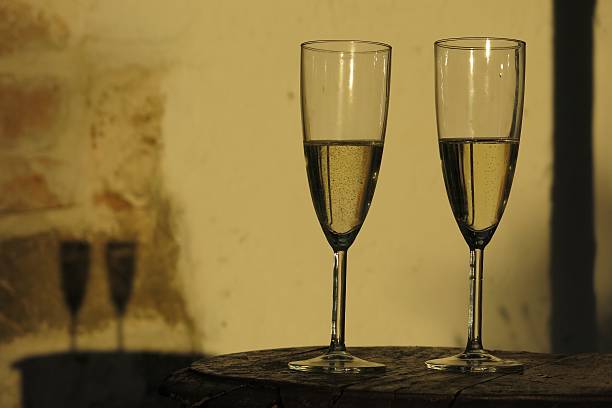istock Two champagne flutes illuminated by afternoon sunlight 499782914