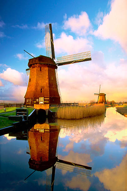 Dutch Windmills Traditional Dutch windmills along a canal netherlands windmill stock pictures, royalty-free photos & images