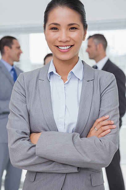 istock Businesswoman posing while colleagues talking together 499784969