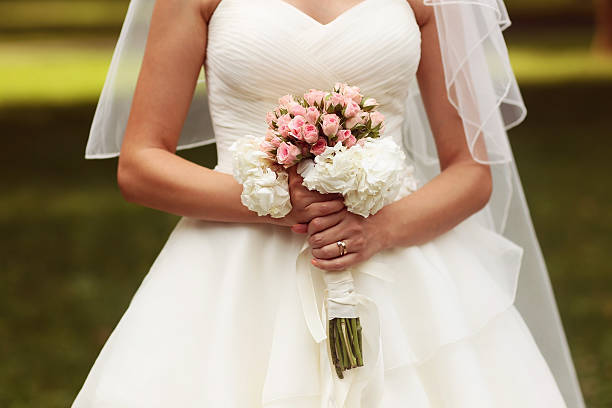istock Beautiful wedding bouquet in hands of the bride 499785121