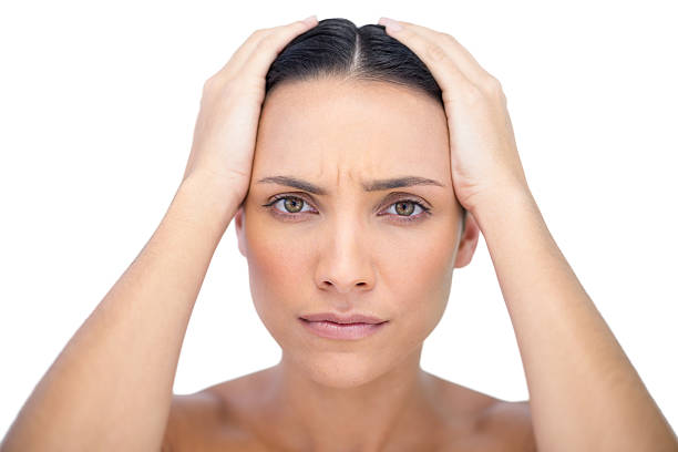 istock Young woman with headache touching her forehead 499785957