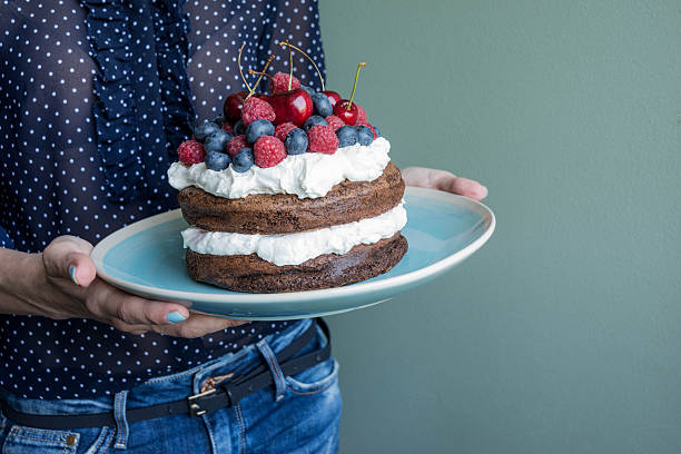 istock beautiful cake with blueberries, raspberries, cherries  and cream 499799008
