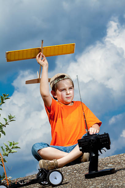 istock Little boy playing with handmade RC airplane toy 499799402