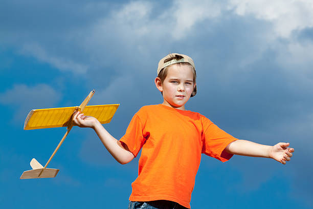 istock Little boy playing with handmade RC airplane toy 499799558