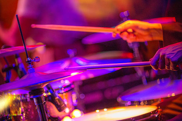 Drummer playing drums on stage view and shot from backstage: drummer playing hihat and snare drum bass drum photos stock pictures, royalty-free photos & images