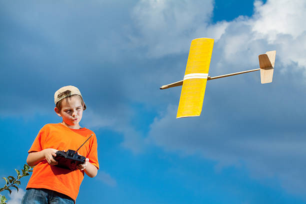 istock Little boy playing with handmade RC airplane toy 499799916